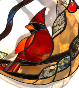 stained glass cardinal on a branch with leaves