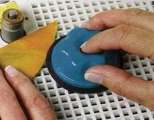 Load image into Gallery viewer, Person using a Grinder Cookie when grinding stained glass
