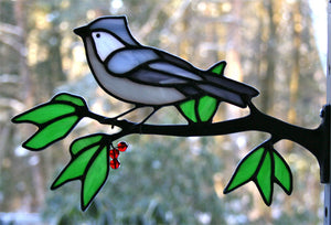 stained glass tufted titmouse on a window frame metal branch with red berries